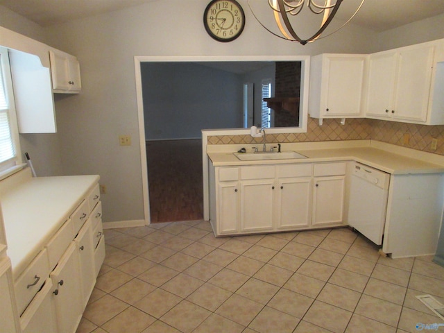 109 Colonial Dr, Scottsboro, AL 35768 - kitchen with light countertops, white dishwasher, a sink, and white cabinets