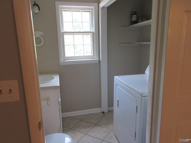 109 Colonial Dr, Scottsboro, AL 35768 - laundry room with light tile patterned floors, laundry area, a sink, baseboards, and washer / clothes dryer