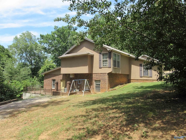 109 Colonial Dr, Scottsboro, AL 35768 - rear view of house with brick siding, a lawn, and stucco siding