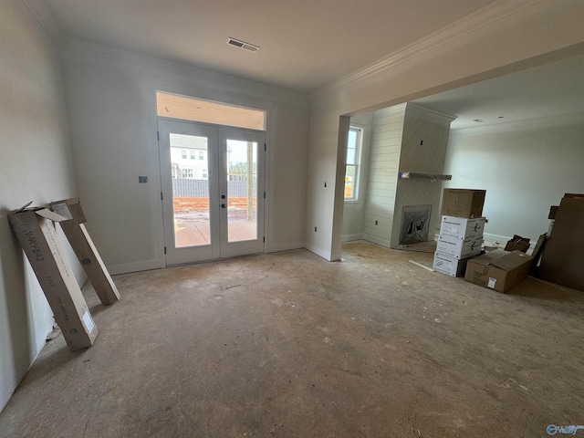 unfurnished living room with crown molding, french doors, and visible vents