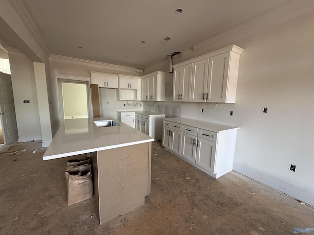 kitchen featuring white cabinetry, ornamental molding, and a kitchen island
