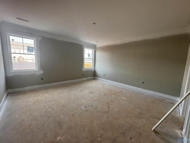 empty room featuring visible vents, baseboards, and ornamental molding