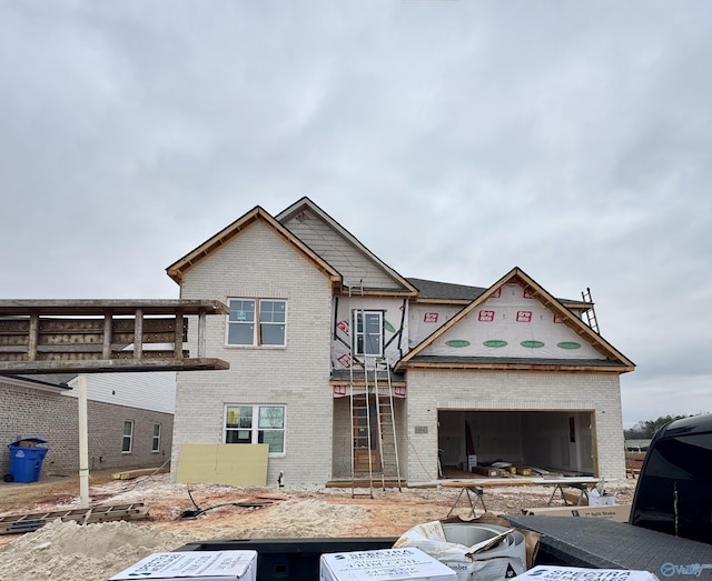 property in mid-construction with brick siding and a garage