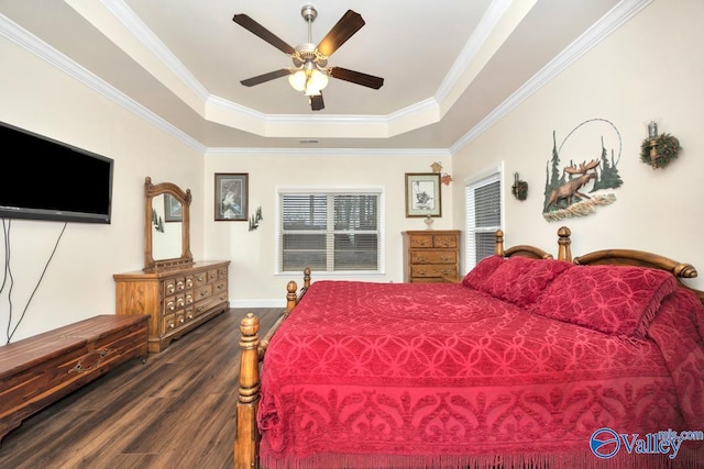 bedroom featuring dark hardwood / wood-style floors, ornamental molding, a raised ceiling, and ceiling fan