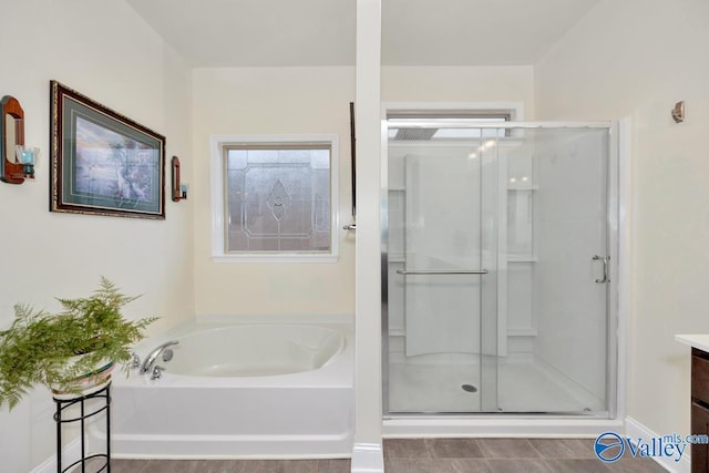 bathroom with vanity and separate shower and tub