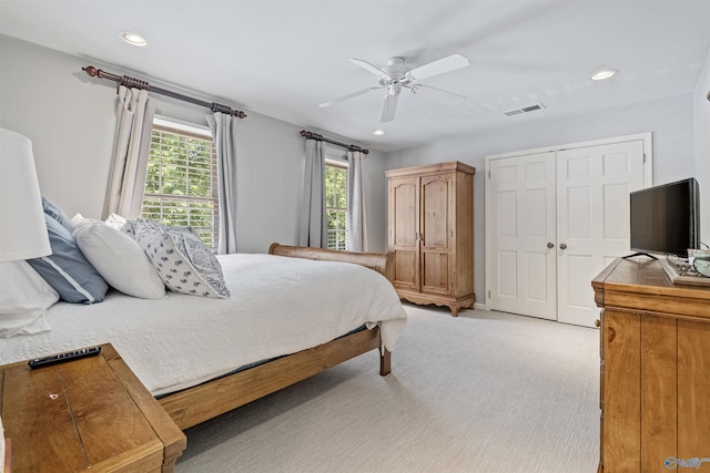 bedroom with a closet, recessed lighting, light colored carpet, and a ceiling fan
