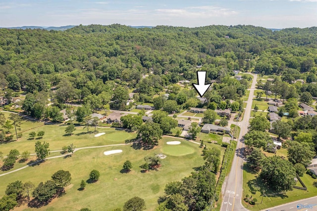 bird's eye view of a heavily wooded area and a golf course