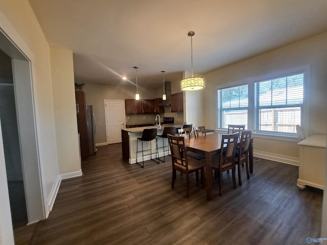 dining room featuring dark wood-style floors and baseboards