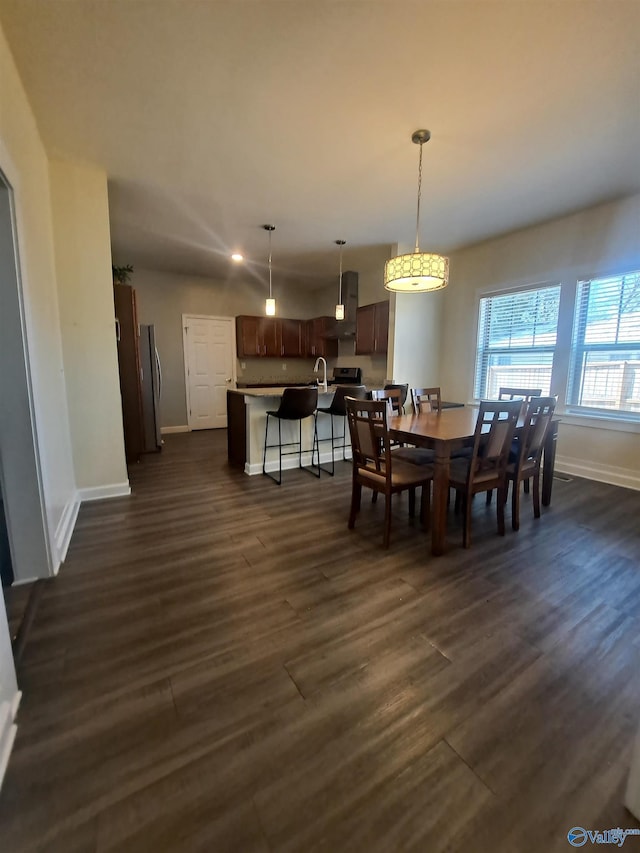 dining room featuring baseboards and dark wood-style flooring