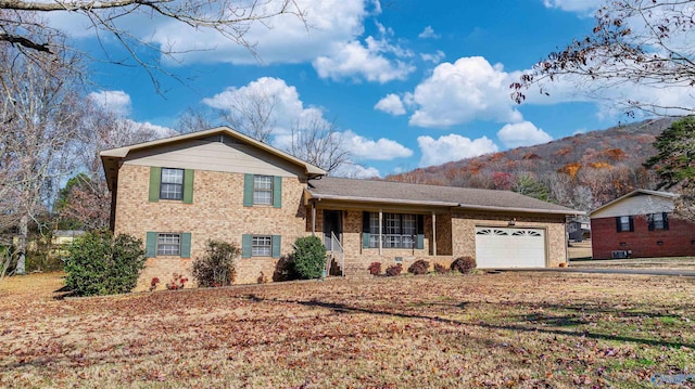 tri-level home featuring a mountain view and a garage