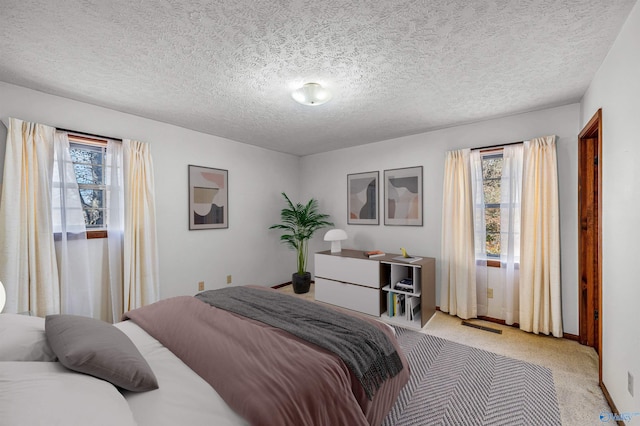 carpeted bedroom featuring a textured ceiling