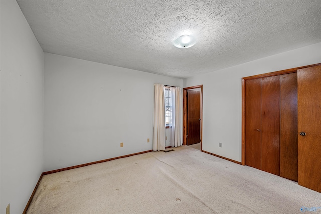 unfurnished bedroom featuring carpet and a textured ceiling