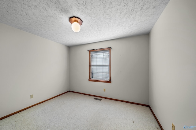 spare room featuring a textured ceiling