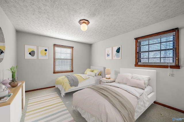 carpeted bedroom featuring a textured ceiling