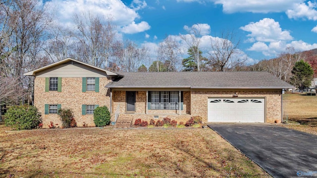 tri-level home featuring a garage and a front lawn