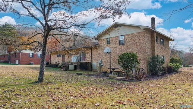 view of side of property with a yard