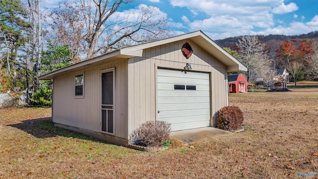 view of outbuilding featuring a lawn and a garage