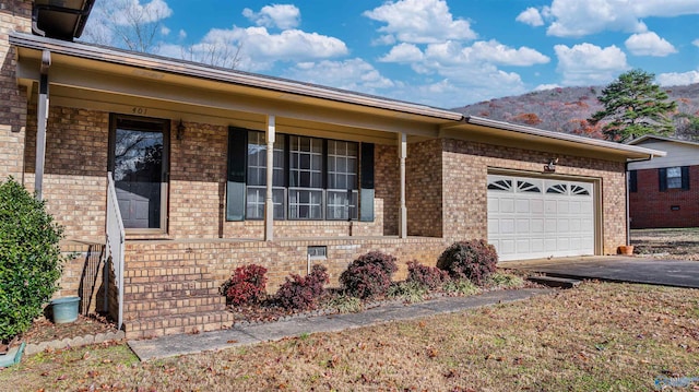 ranch-style house with covered porch and a garage