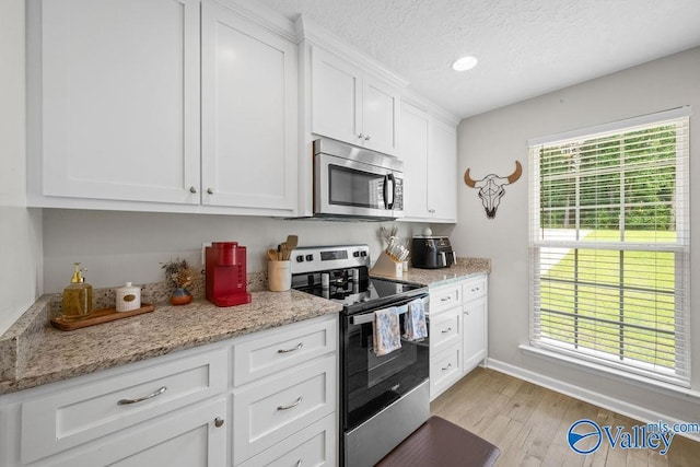 713 Rabbittown Rd, Glencoe, AL 35905 - kitchen with stainless steel appliances, light wood-style flooring, white cabinetry, baseboards, and recessed lighting