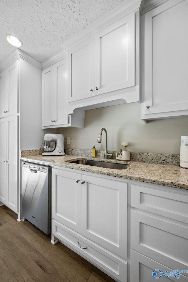 713 Rabbittown Rd, Glencoe, AL 35905 - kitchen with dishwasher, dark wood finished floors, a sink, white cabinetry, and light stone counters
