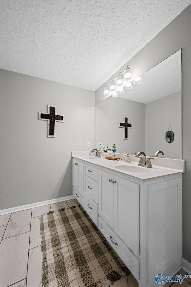 713 Rabbittown Rd, Glencoe, AL 35905 - bathroom featuring double vanity, baseboards, and a textured ceiling
