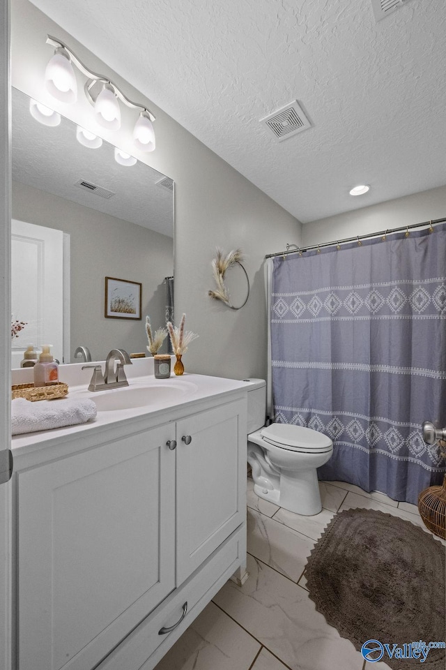 713 Rabbittown Rd, Glencoe, AL 35905 - full bath featuring toilet, vanity, marble finish floors, and a textured ceiling