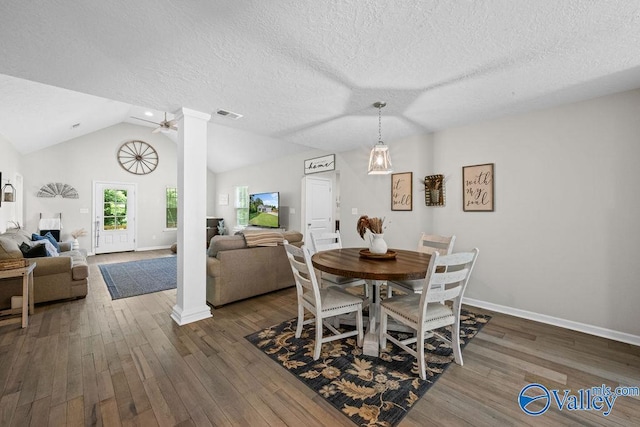 713 Rabbittown Rd, Glencoe, AL 35905 - dining area featuring baseboards, dark wood-type flooring, vaulted ceiling, a textured ceiling, and ornate columns