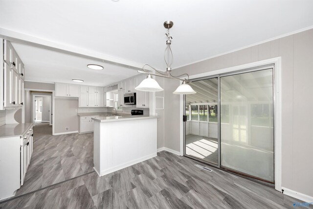 2501 Andrew Jackson Way NE, Huntsville, AL 35811 - kitchen with stainless steel microwave, baseboards, and white cabinetry