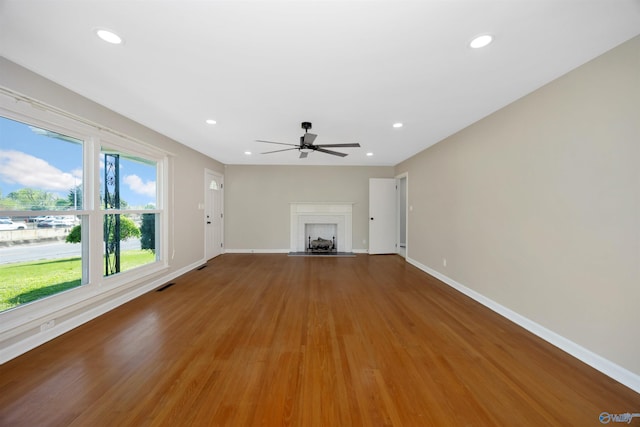 2501 Andrew Jackson Way NE, Huntsville, AL 35811 - unfurnished living room with a fireplace with flush hearth, ceiling fan, baseboards, and visible vents