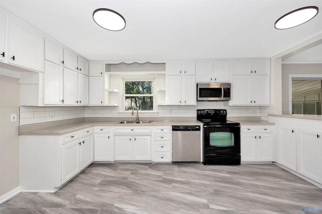 2501 Andrew Jackson Way NE, Huntsville, AL 35811 - kitchen featuring open shelves, decorative backsplash, a sink, and appliances with stainless steel finishes