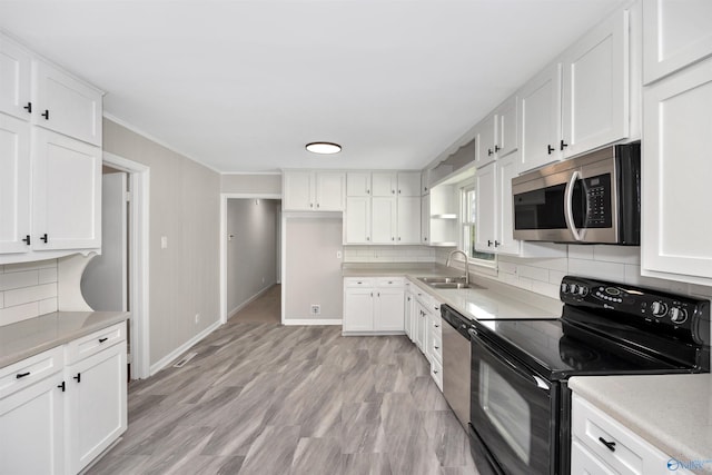 2501 Andrew Jackson Way NE, Huntsville, AL 35811 - kitchen featuring tasteful backsplash, white cabinetry, stainless steel appliances, and a sink