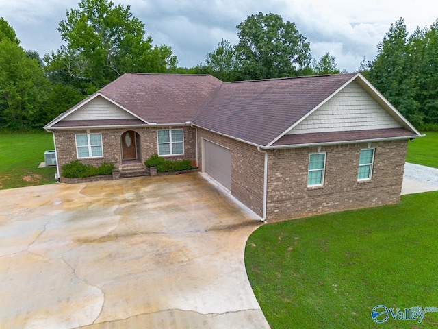 ranch-style home featuring a garage and a front yard