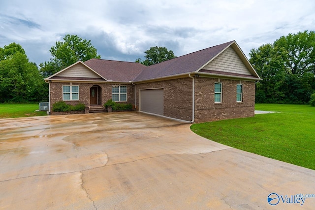 ranch-style house with a garage, a front lawn, and central air condition unit