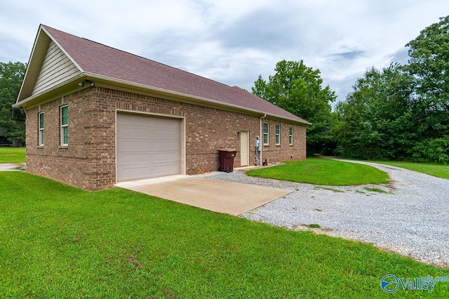 view of side of home featuring a garage and a lawn