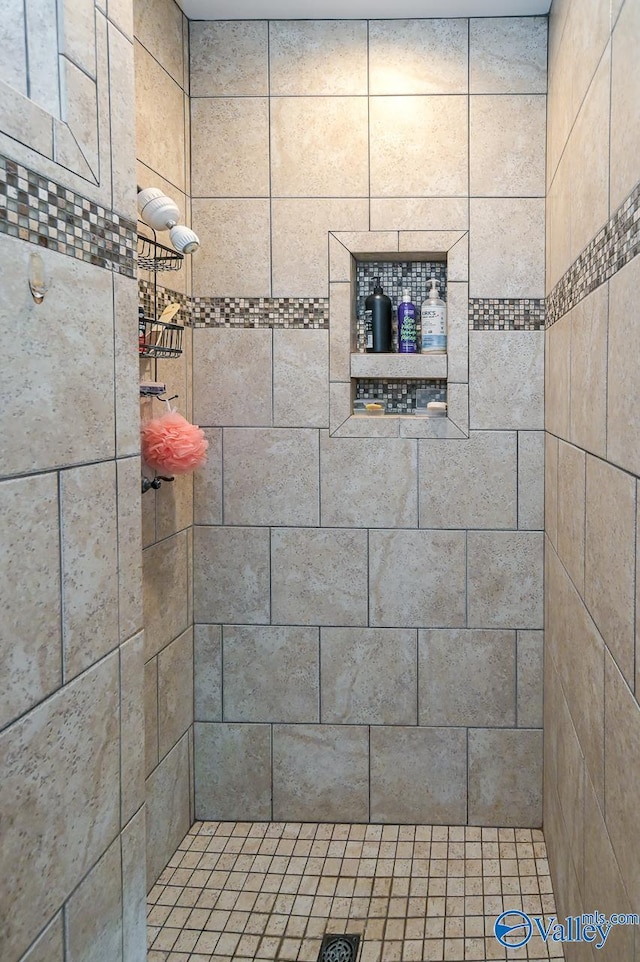 bathroom with a tile shower