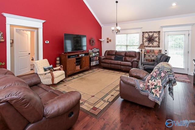 living room featuring lofted ceiling, crown molding, a chandelier, and a healthy amount of sunlight