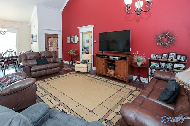 living room featuring ornamental molding, a notable chandelier, and high vaulted ceiling