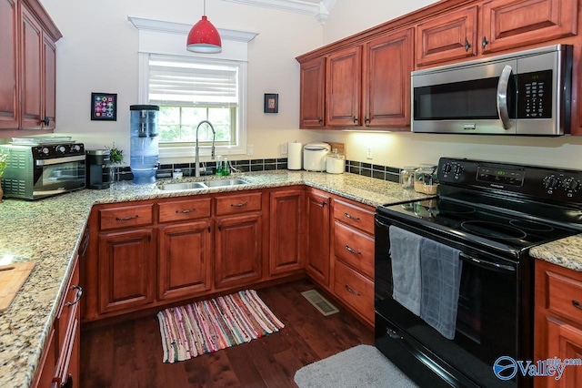 kitchen featuring sink, light stone counters, black electric range, ornamental molding, and pendant lighting