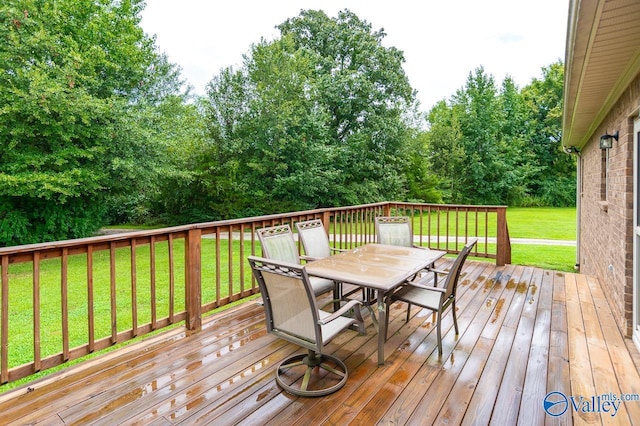 wooden terrace featuring a yard