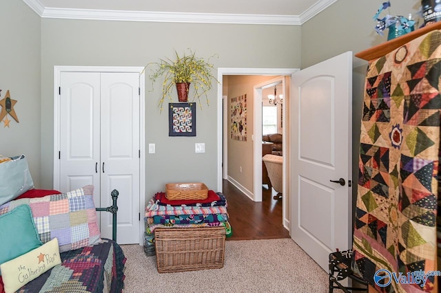 bedroom featuring crown molding, carpet floors, a closet, and a notable chandelier