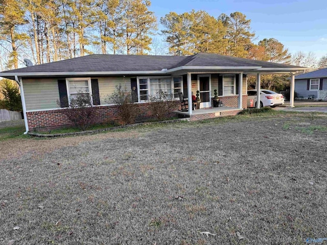 single story home with a front lawn, covered porch, and a carport