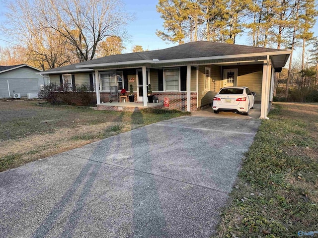 ranch-style house featuring a front yard, a porch, and a carport