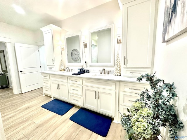 bathroom with vanity and hardwood / wood-style flooring