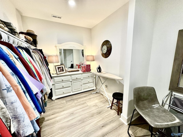 walk in closet with light wood-type flooring