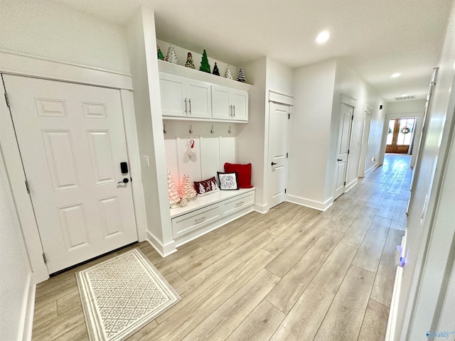 mudroom with light hardwood / wood-style floors