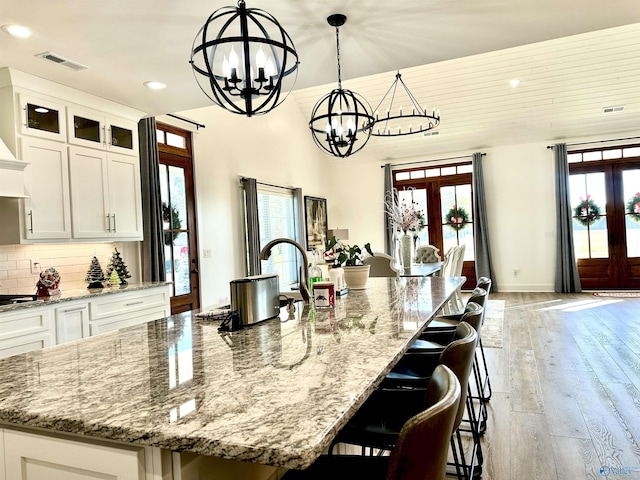 kitchen with french doors, hanging light fixtures, and a spacious island