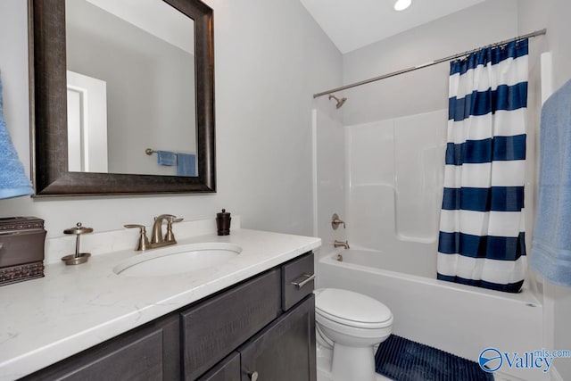 full bathroom with vanity, shower / bath combo, and toilet