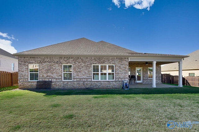 back of house featuring a patio area, ceiling fan, and a yard