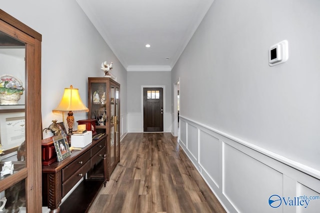 doorway with crown molding and dark wood-type flooring