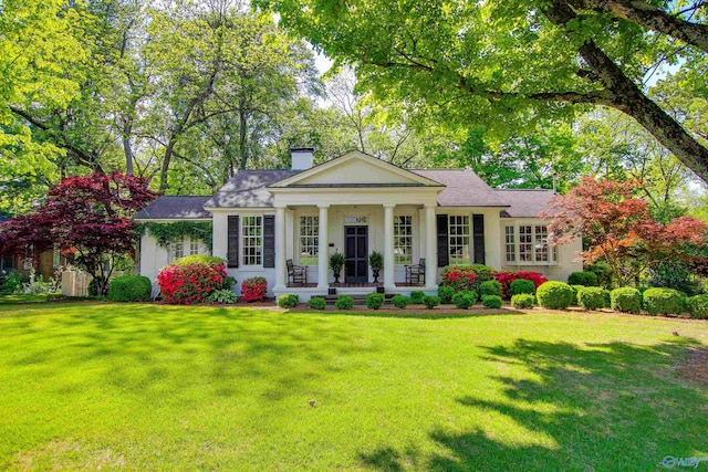 greek revival inspired property with a front yard